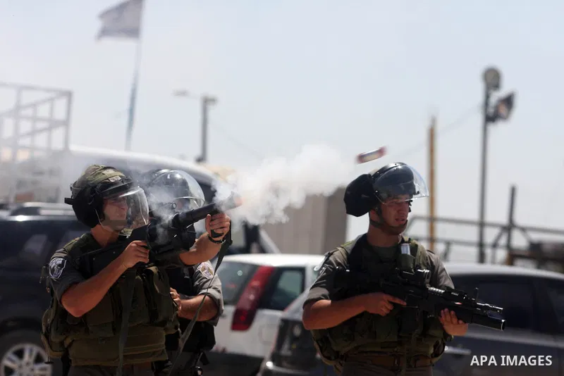Israeli soldiers fire tear gas at Palestinian protesters outside the Ofer military prison, near the West Bank city of Ramallah, on August 28, 2012, during a demonstration in solidarity with Palestinian prisoners being he...