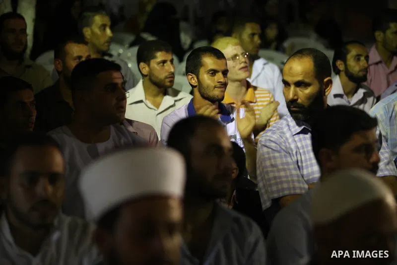 Palestinians listen to sufis songs performed by Sufi artists during celebration in Gaza city on Aug 28, 2012. Mystic songs symbolizing peace, brotherhood and love. Photo by Majdi Fathi