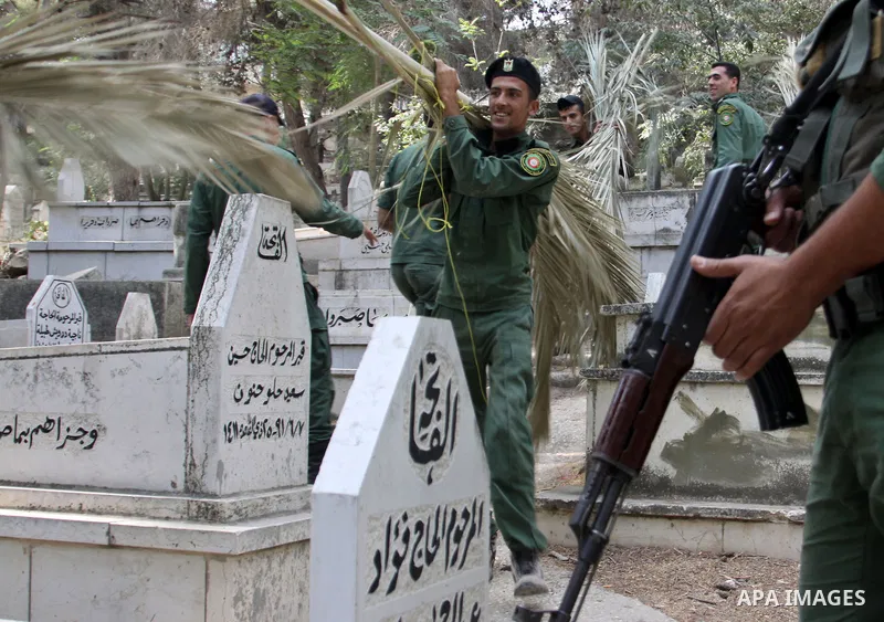 Palestinian security members volunteer clean the cemeteries during the campaign "Cleanliness " in the West Bank city OF Nablus, on Aug. 29, 2012. Photo by Nedal Eshtayah