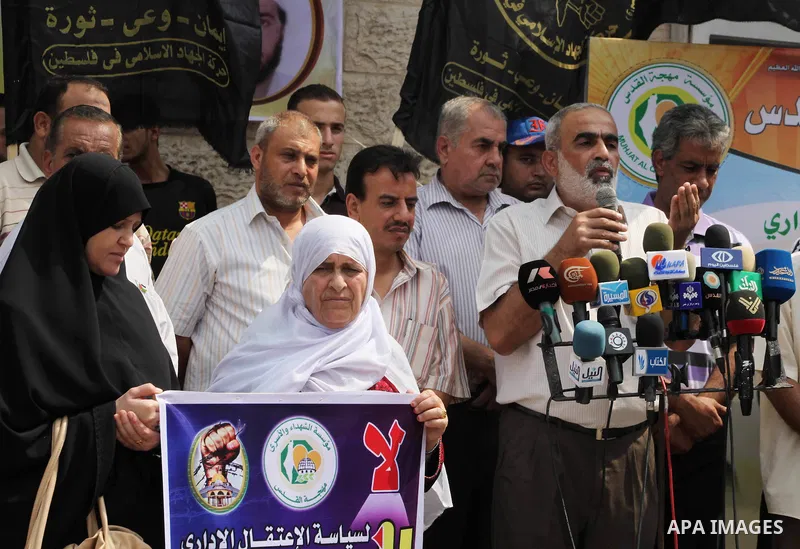 Palestinians hold up signs during a protest against administrative detention of Palestinian prisoners In Israeli jails, in front of the Red Cross headquarters in Gaza City on Aug. 29, 2012. Photo by Ashraf Amra