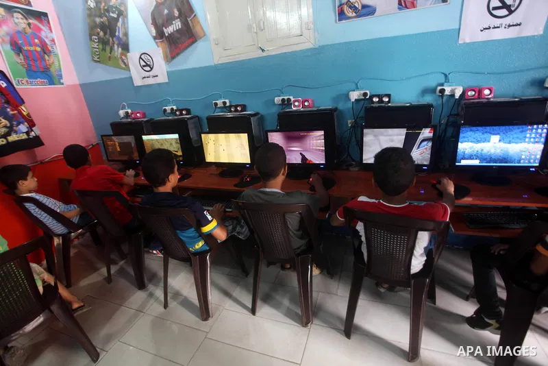 Palestinian children play computer games in a video game club, four days before the beginning of new school year in Gaza city, on Aug 29, 2012. Next Sunday the First day for the new school year according to Palestinian M...