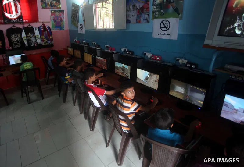 Palestinian children play computer games in a video game club, four days before the beginning of new school year in Gaza city, on Aug 29, 2012. Next Sunday the First day for the new school year according to Palestinian M...