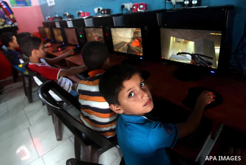 Palestinian children play computer games in a video game club, four days before the beginning of new school year in Gaza city, on Aug 29, 2012. Next Sunday the First day for the new school year according to Palestinian M...