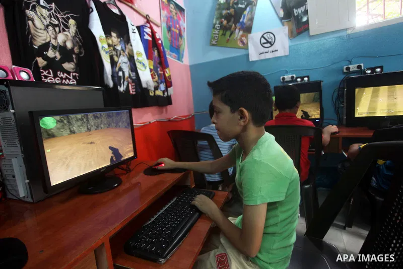 Palestinian children play computer games in a video game club, four days before the beginning of new school year in Gaza city, on Aug 29, 2012. Next Sunday the First day for the new school year according to Palestinian M...
