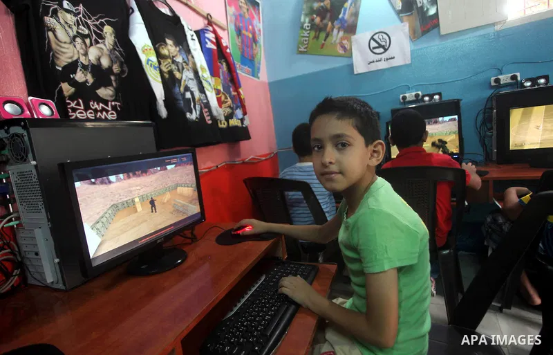 Palestinian children play computer games in a video game club, four days before the beginning of new school year in Gaza city, on Aug 29, 2012. Next Sunday the First day for the new school year according to Palestinian M...