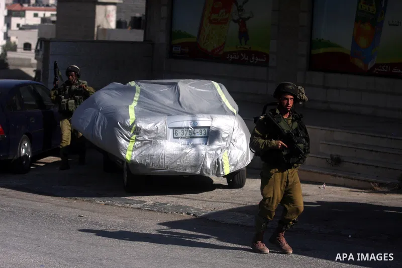 Israeli soldiers fire tear gas at Palestinian youths during an incursion to Om al-Sharayet neighborhood, in the West Bank city of Ramallah, Wednesday, Aug 29, 2012. Israeli soldiers raided a store in Om al-Sharayet and l...