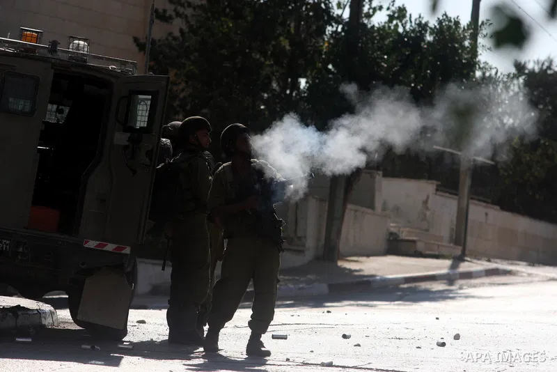 Israeli soldiers fire tear gas at Palestinian youths during an incursion to Om al-Sharayet neighborhood, in the West Bank city of Ramallah, Wednesday, Aug 29, 2012. Israeli soldiers raided a store in Om al-Sharayet and l...