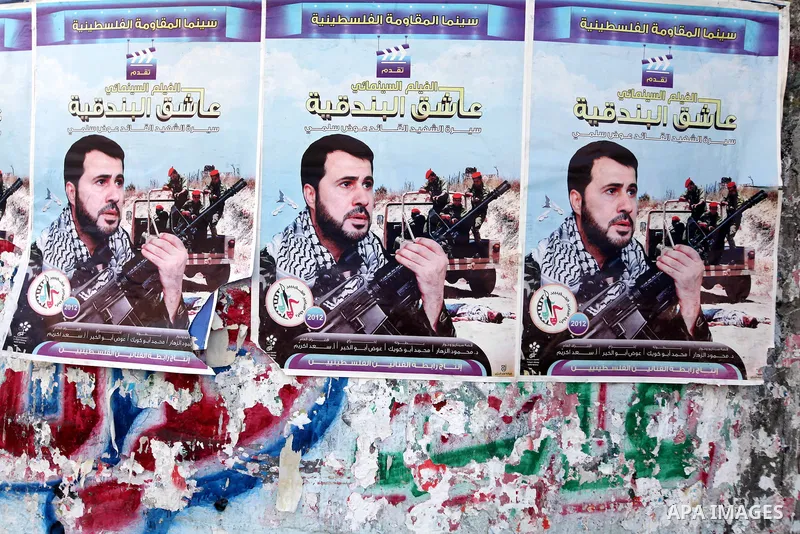 A picture for the leader in Izz al-Din al-Qassam, the military wing of hamas, the martyr Awad Silmi, on a poster invites Palestinians to view a cinema movie about his life, in Gaza city, on Aug 28, 2012. Hamas prepare to...