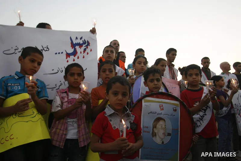 Palestinian children hold candles during a protest in Rafah in the southern Gaza Strip, against an Israeli court's ruling, August 29, 2012. The Israeli court on Tuesday cleared Israel's military of any blame for the deat...
