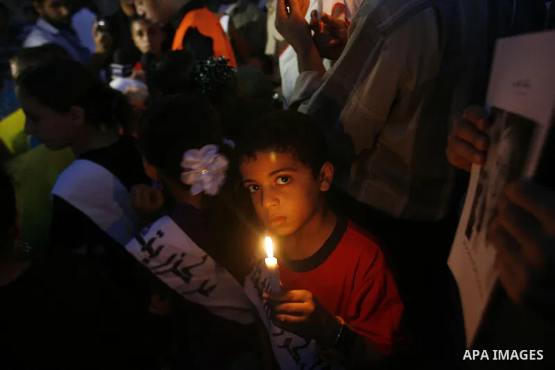 Palestinian children hold candles during a protest in Rafah in the southern Gaza Strip, against an Israeli court's ruling, August 29, 2012. The Israeli court on Tuesday cleared Israel's military of any blame for the deat...
