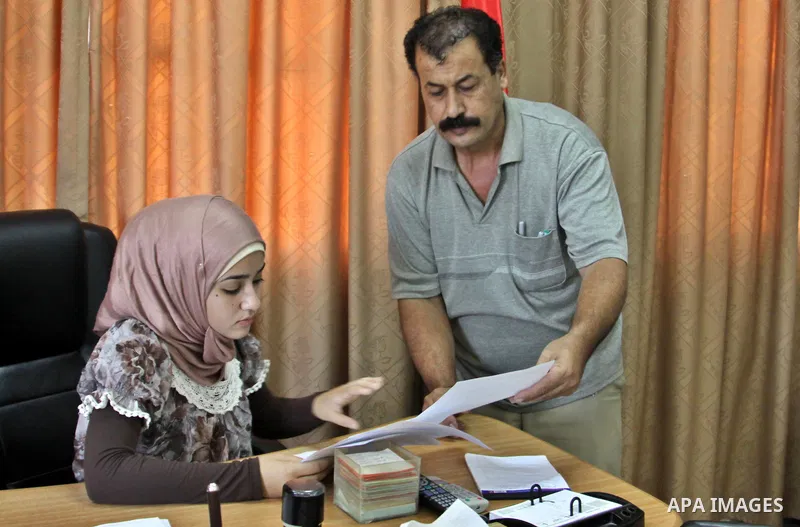 Palestinian mayor teenager Bashaer Othman, 15, sits behind her desk at the town hall of the West Bank village of Allar, north of Tulkarem, on August 30, 2012. Othman became mayor as part of a program from Allar's municip...
