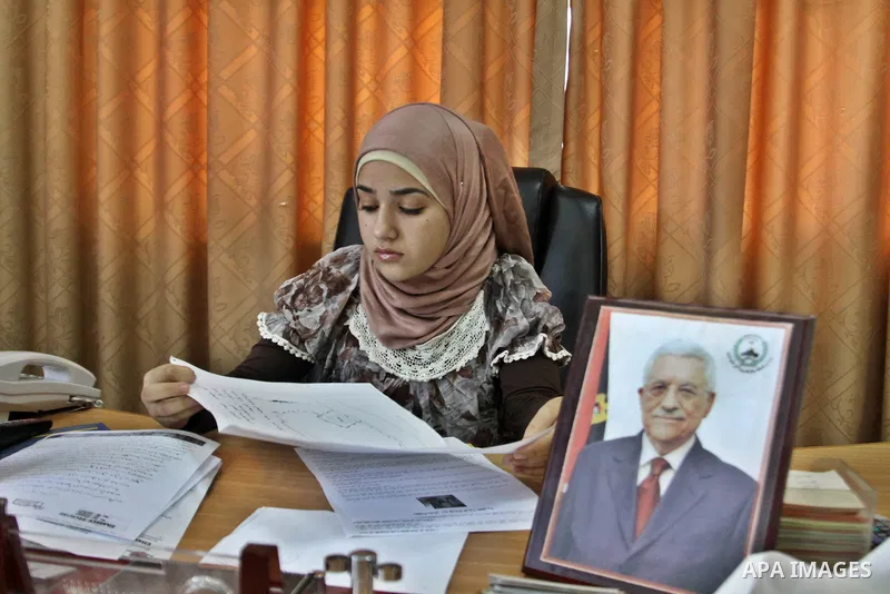 Palestinian mayor teenager Bashaer Othman, 15, sits behind her desk at the town hall of the West Bank village of Allar, north of Tulkarem, on August 30, 2012. Othman became mayor as part of a program from Allar's municip...