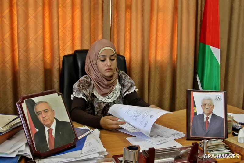 Palestinian mayor teenager Bashaer Othman, 15, sits behind her desk at the town hall of the West Bank village of Allar, north of Tulkarem, on August 30, 2012. Othman became mayor as part of a program from Allar's municip...