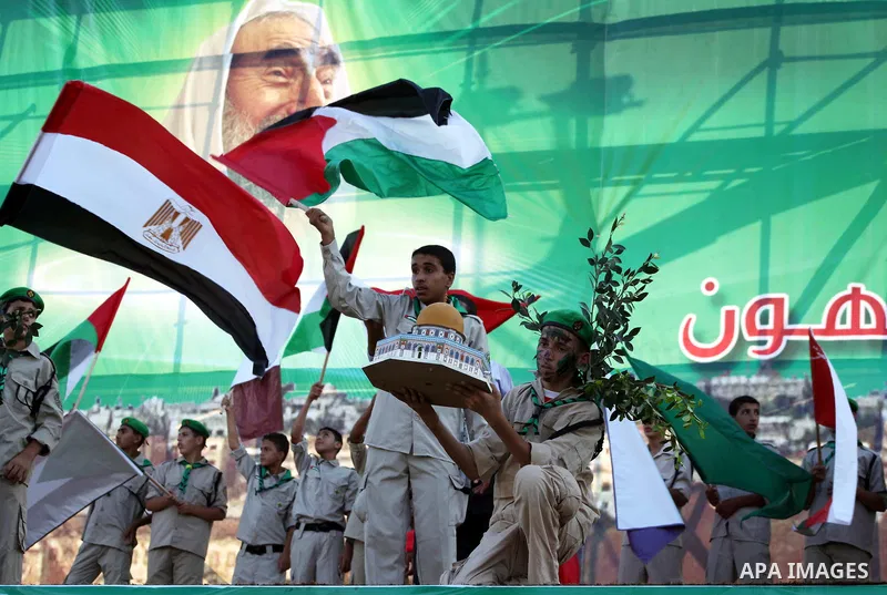 Palestinian boy scouts hold Islamic countries flags during a festival entitled "Jerusalem in our eyes"organized by Hamas movement, marking the 43rd anniversary of burning down al-Aqsa mosque in Gaza city on 30 Aug 2012....