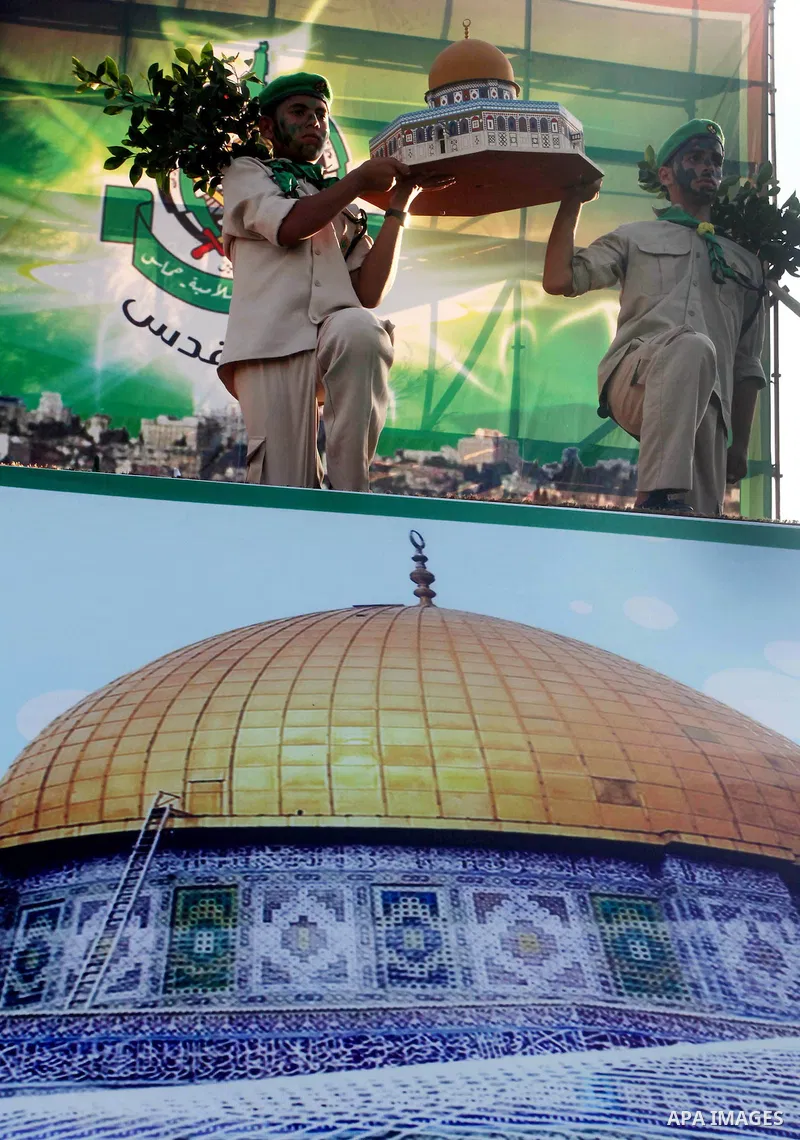 Palestinian boy scouts carry statues of the Dome of the Rock mosque during a festival entitled "Jerusalem in our eyes" organized by Hamas movement, marking the 43rd anniversary of burning down al-Aqsa mosque in Gaza city...