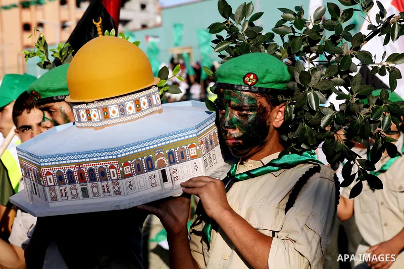 Palestinian boy scouts carry statues of the Dome of the Rock mosque during a festival entitled "Jerusalem in our eyes" organized by Hamas movement, marking the 43rd anniversary of burning down al-Aqsa mosque in Gaza city...