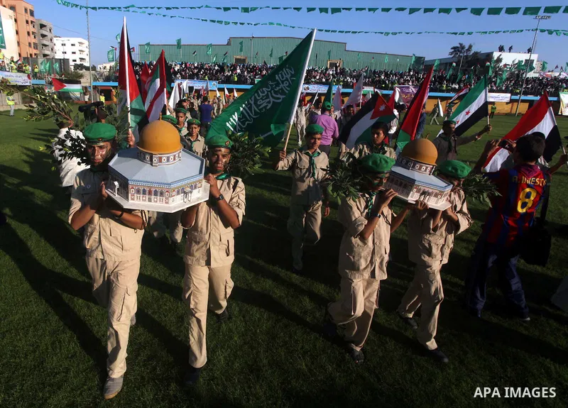 Palestinian boy scouts carry statues of the Dome of the Rock mosque during a festival entitled "Jerusalem in our eyes" organized by Hamas movement, marking the 43rd anniversary of burning down al-Aqsa mosque in Gaza city...