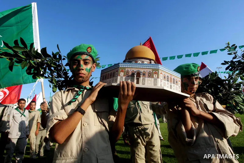 Palestinian boy scouts carry statues of the Dome of the Rock mosque during a festival entitled "Jerusalem in our eyes" organized by Hamas movement, marking the 43rd anniversary of burning down al-Aqsa mosque in Gaza city...
