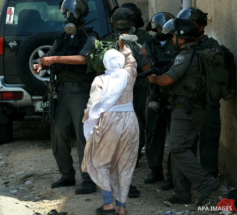 Palestinian woman attacks Israeli soldiers using her shoes during clashes against the expropriation of Palestinian land by Israel in the village of Kafr Qaddum, near the West Bank city of Nablus on August 31, 2012. Photo...