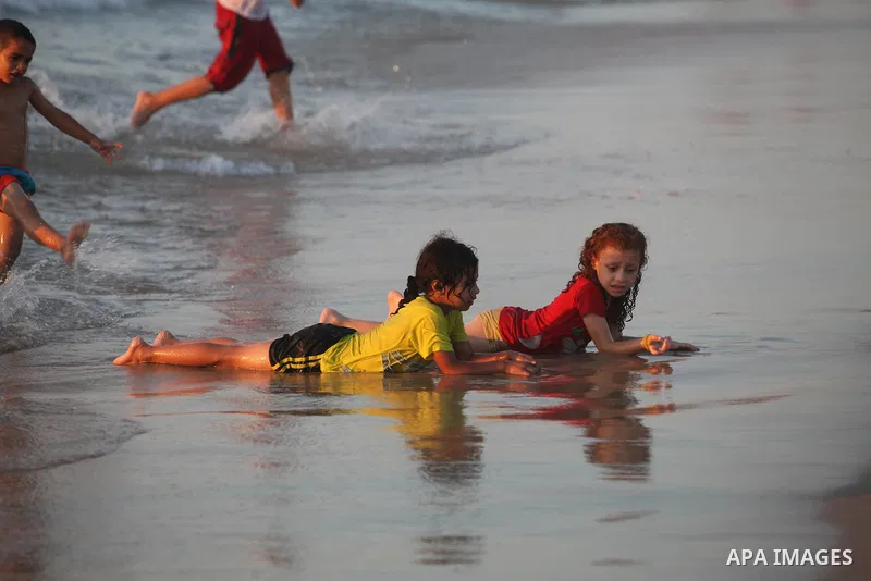 Palestinian children play at the beach during the last Friday holiday before the beginning of new school year in Gaza city, Aug 31, 2012. Next Sunday is the First day for the new school year according to Palestinian Mini...