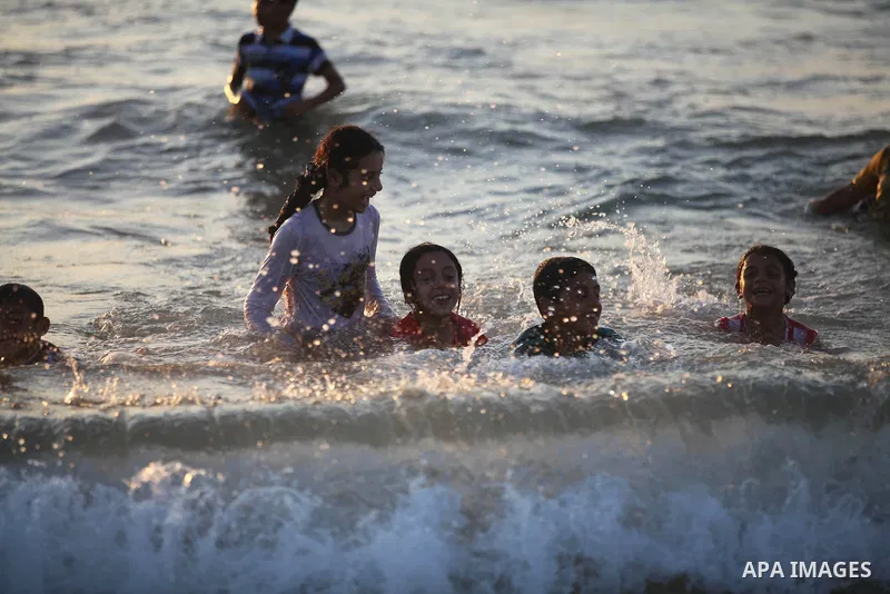 Palestinian children play at the beach during the last Friday holiday before the beginning of new school year in Gaza city, Aug 31, 2012. Next Sunday is the First day for the new school year according to Palestinian Mini...