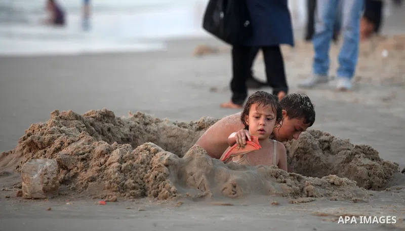 Palestinian children play at the beach during the last Friday holiday before the beginning of new school year in Gaza city, Aug 31, 2012. Next Sunday is the First day for the new school year according to Palestinian Mini...