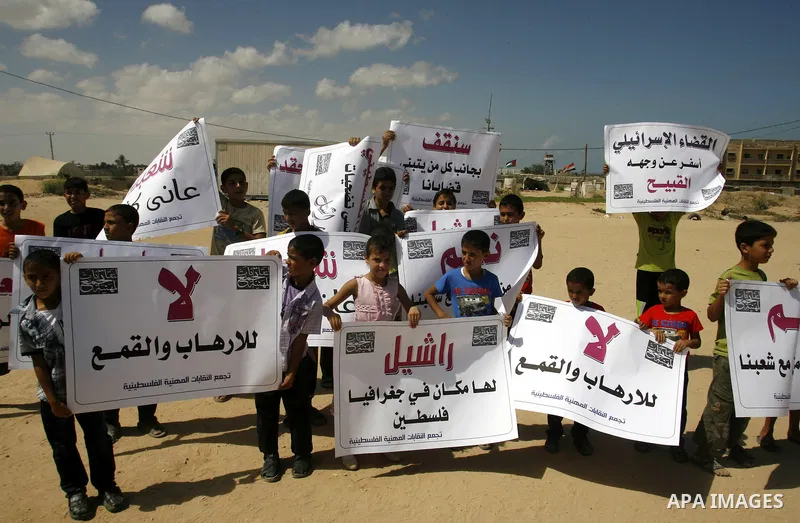 Palestinian children attend a protest calling for justice for Rachel Corrie in Rafah, Gaza Strip, Sep. 01, 2012. An Israeli court ruled that Israel did not intentionally kill pro-Palestinian activist Rachel Corrie, run o...