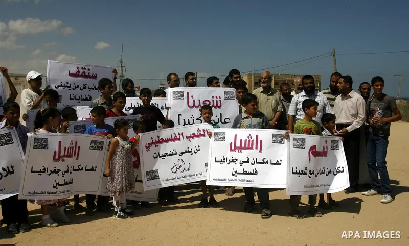 Palestinian children attend a protest calling for justice for Rachel Corrie in Rafah, Gaza Strip, Sep. 01, 2012. An Israeli court ruled that Israel did not intentionally kill pro-Palestinian activist Rachel Corrie, run o...