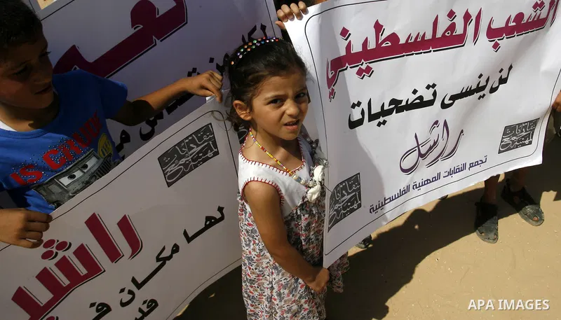 Palestinian children attend a protest calling for justice for Rachel Corrie in Rafah, Gaza Strip, Sep. 01, 2012. An Israeli court ruled that Israel did not intentionally kill pro-Palestinian activist Rachel Corrie, run o...