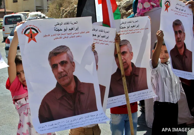Palestinian children hold portraits of Palestinian prisoner Ibrahim Abu Hijleh, outside the Red Cross building in the West Bank city of Nablus on Sep. 01, 2012. as they protest against Israel's policy of administrative d...