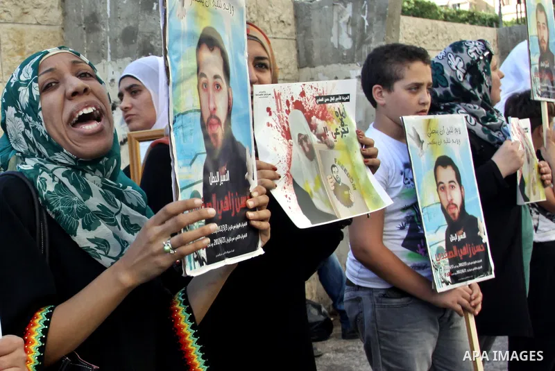 Palestinian protesters hold up banners and portraits of a prisoners jailed in Israel On hunger strike,during a rally in solidarity with prisoners in Israeli jails, in the West Bank city of Nablus on sep 1, 2012. Photo by...