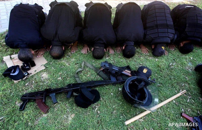 Members of Hamas security forces pray as others patrol in a street in Gaza city September 1, 2012. Photo by Ashraf Amra