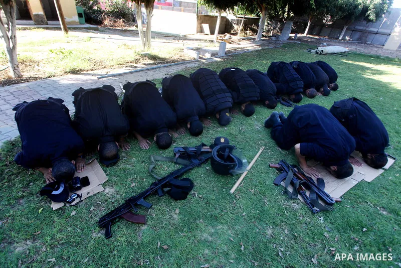 Members of Hamas security forces pray as others patrol in a street in Gaza city September 1, 2012. Photo by Ashraf Amra
