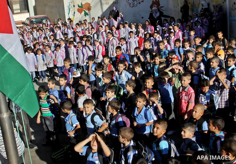 Palestinian students return back to their schools in the morning of the first day of the new year study in the West Bnak city of Nablus on Sep. 02, 2012. The academic year began in the Gaza Strip and West Bank on Sept. 0...