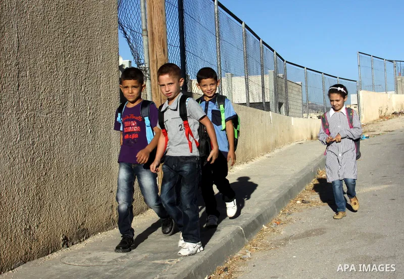 Palestinian students return back to their schools in the morning of the first day of the new year study in the West Bnak city of Nablus on Sep. 02, 2012. The academic year began in the Gaza Strip and West Bank on Sept. 0...