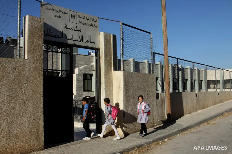 Palestinian students return back to their schools in the morning of the first day of the new year study in the West Bnak city of Nablus on Sep. 02, 2012. The academic year began in the Gaza Strip and West Bank on Sept. 0...