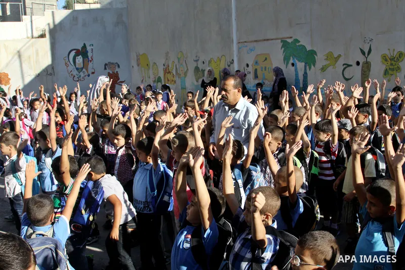 Palestinian students return back to their schools in the morning of the first day of the new year study in the West Bnak city of Nablus on Sep. 02, 2012. The academic year began in the Gaza Strip and West Bank on Sept. 0...