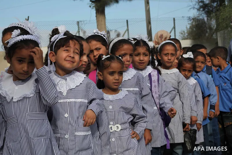 Palestinian students return back to their schools "UNRWA" in the morning of the first day of the new year study in Gaza city on Sep. 02, 2012. The academic year began in the Gaza Strip and West Bank on Sept. 02. Photo by...
