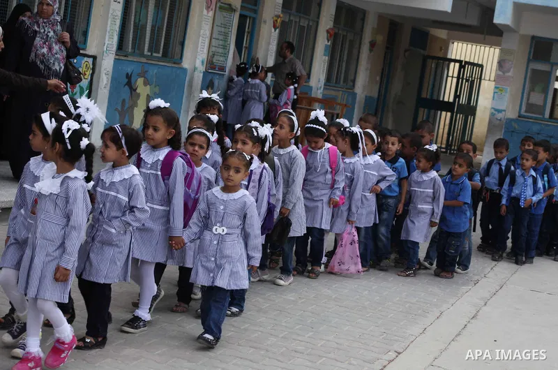 Palestinian students return back to their schools "UNRWA" in the morning of the first day of the new year study in Gaza city on Sep. 02, 2012. The academic year began in the Gaza Strip and West Bank on Sept. 02. Photo by...