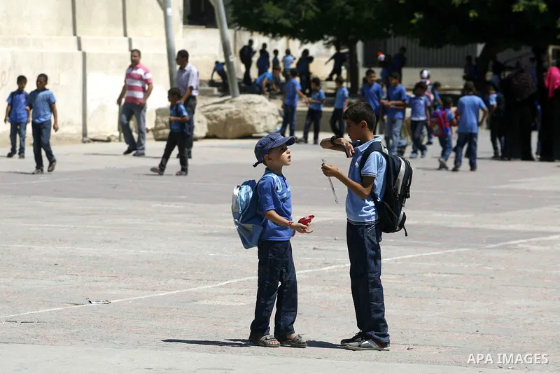 Palestinian students return back to their schools in the morning of the first day of the new year study in Rafah in the southern Gaza Strip. 02, 2012. The academic year began in the Gaza Strip and West Bank on Sept. 02....