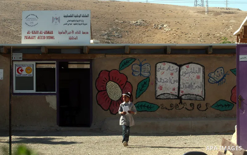 A Palestinian student walks at her school during the visit of Palestinian Prime Minister Salam Fayyad to the "al-Khan al-Ahmar" school, on the first day of the new school year, in Abu Hindi valley in the bedouin, in occu...