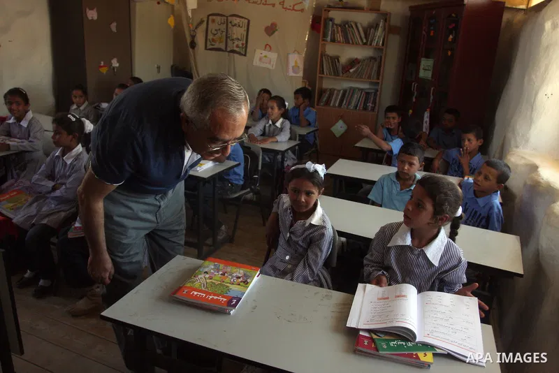 Palestinian Prime Minister Salam Fayyad visits the school "al-Khan al-Ahmar", on the first day of the new school year, in Abu Hindi valley in the bedouin, in occupied West Bank near Jericho, on September 2, 2012. Photo b...