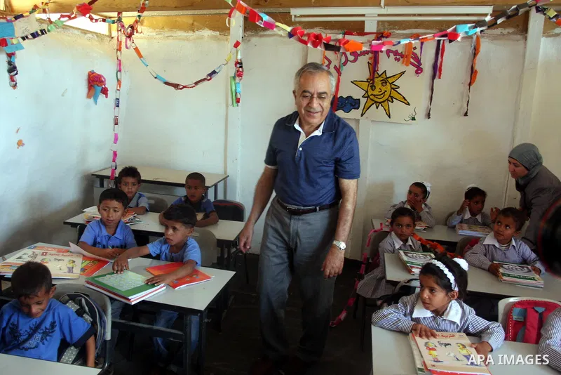 Palestinian Prime Minister Salam Fayyad visits the school "al-Khan al-Ahmar", on the first day of the new school year, in Abu Hindi valley in the bedouin, in occupied West Bank near Jericho, on September 2, 2012. Photo b...
