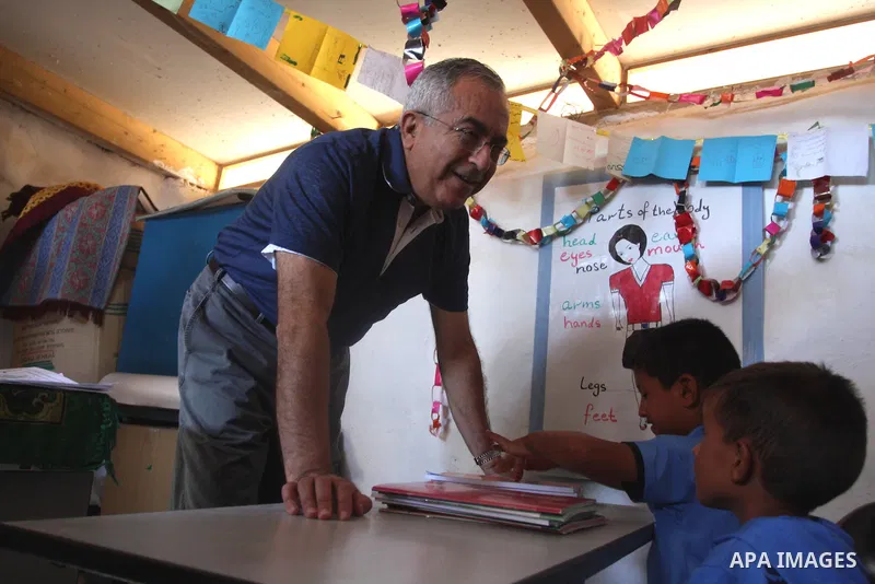 Palestinian Prime Minister Salam Fayyad visits the school "al-Khan al-Ahmar", on the first day of the new school year, in Abu Hindi valley in the bedouin, in occupied West Bank near Jericho, on September 2, 2012. Photo b...