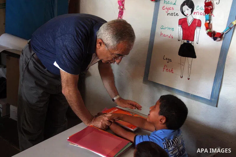 Palestinian Prime Minister Salam Fayyad visits the school "al-Khan al-Ahmar", on the first day of the new school year, in Abu Hindi valley in the bedouin, in occupied West Bank near Jericho, on September 2, 2012. Photo b...