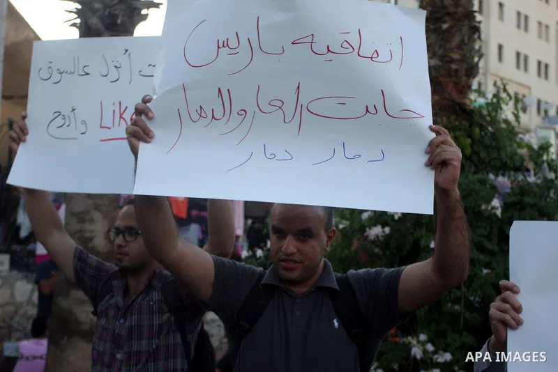 Palestinian protesters hold signs during a demonstration against the price rises, in the West Bank city of Ramallah, on September 02, 2012. Photo by Issam Rimawi