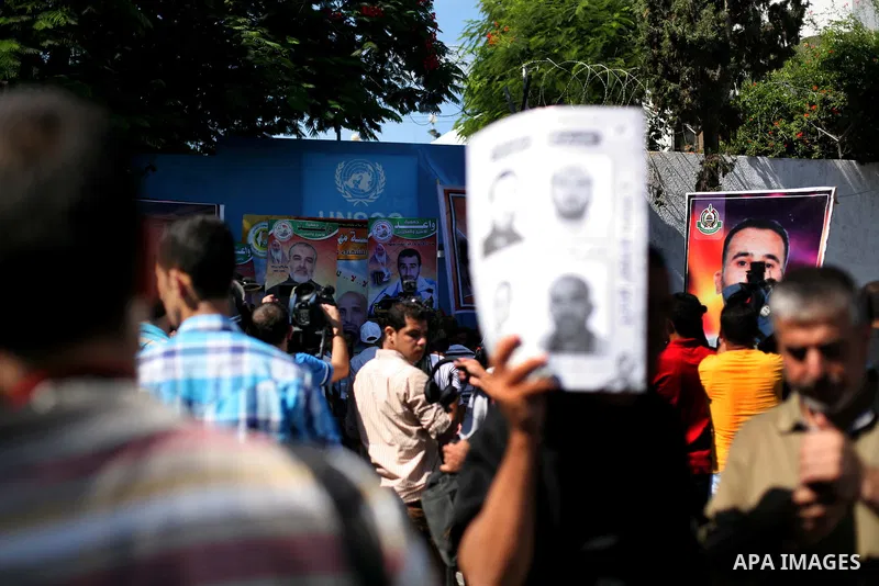 Palestinians hold a placard depicting jailed relatives during a protest in Gaza City calling for the release of Palestinian prisoners from Israeli jails September 3, 2012. Photo by Ashraf Amra