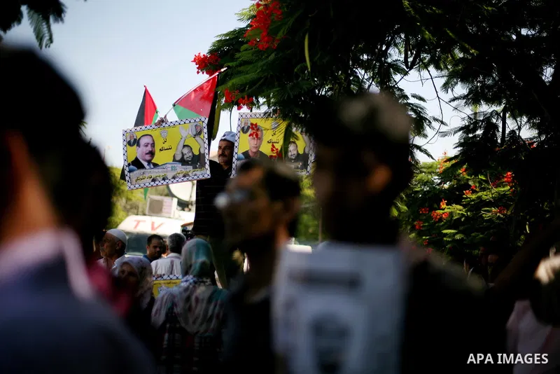Palestinians hold a placard depicting jailed relatives during a protest in Gaza City calling for the release of Palestinian prisoners from Israeli jails September 3, 2012. Photo by Ashraf Amra