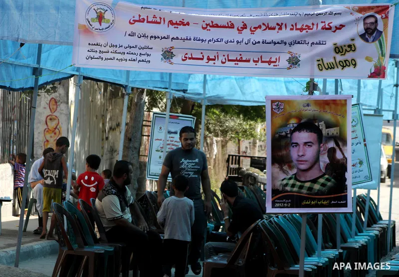 Palestinians sit in the mourning tent of Ihab Abu Nada in the Shati refugee camp in Gaza City, Monday, Sept. 3, 2012. The death of a young Gaza man who set himself on fire because he could not find a job has sent shockwa...