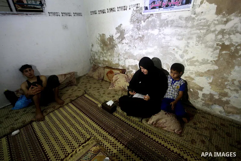Palestinian Nadia Abu Nada holds a picture of her son Ihab Abu Nada at her home in the Shati refugee camp in Gaza City, Monday, Sept. 3, 2012. The death of a young Gaza man who set himself on fire because he could not fi...